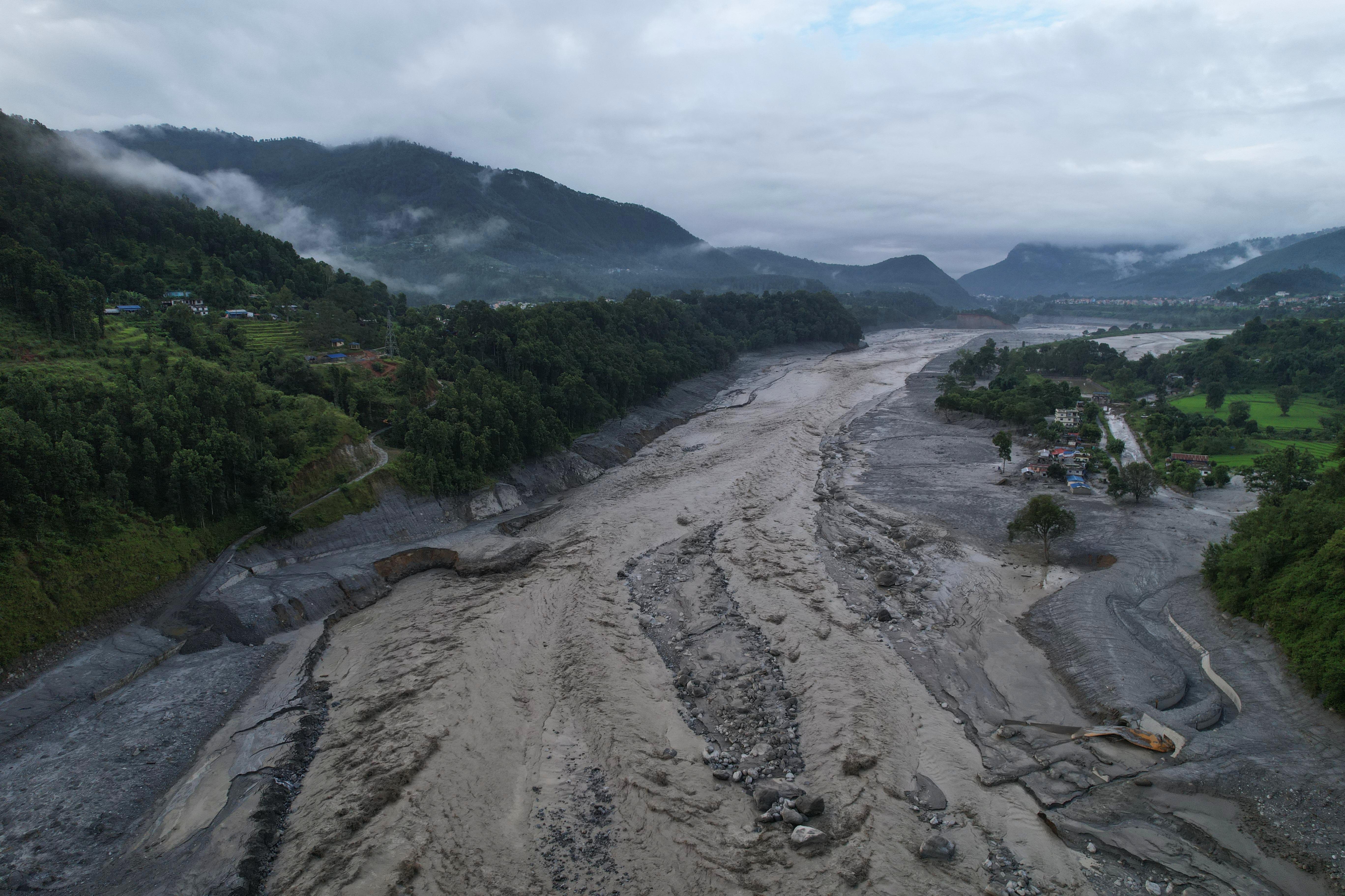 A drone view shows a major section of Pasang Lhamu highway washed away along swollen Trishuli river by recent flash floods cutting off Rasuwa district from Nuwakot area, Nepal, Monday, Aug. 31, 2026.